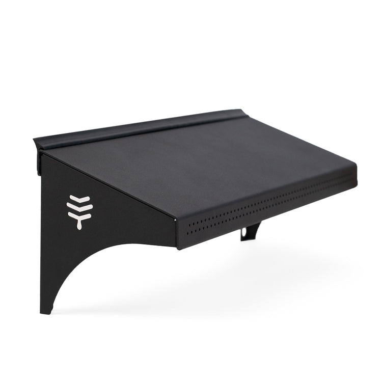 A black hive weather guard designed to protect the entrance of a bee hive from weather conditions.